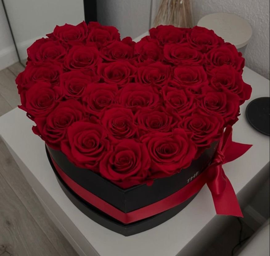 Red roses in black heart box